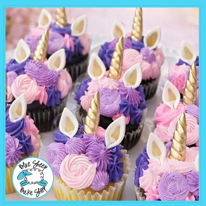 Unicorn cupcakes with pink and purple buttercream swirls, gold horns, and edible ears from Blue Sheep Bake Shop in Somerville NJ