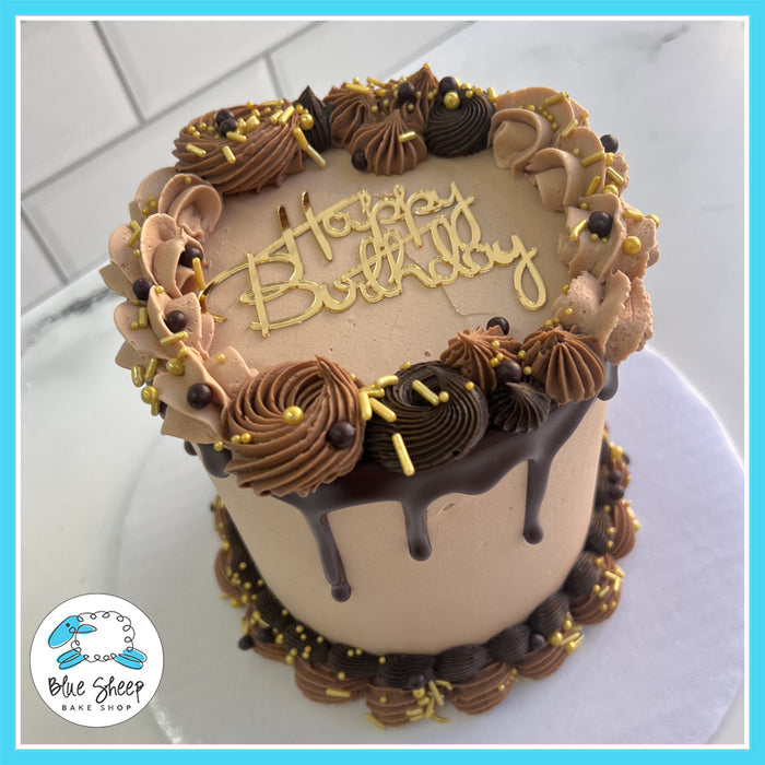 Chocolate birthday cake with ganache drip, chocolate buttercream swirls, and gold sprinkles, perfect for elegant celebrations.