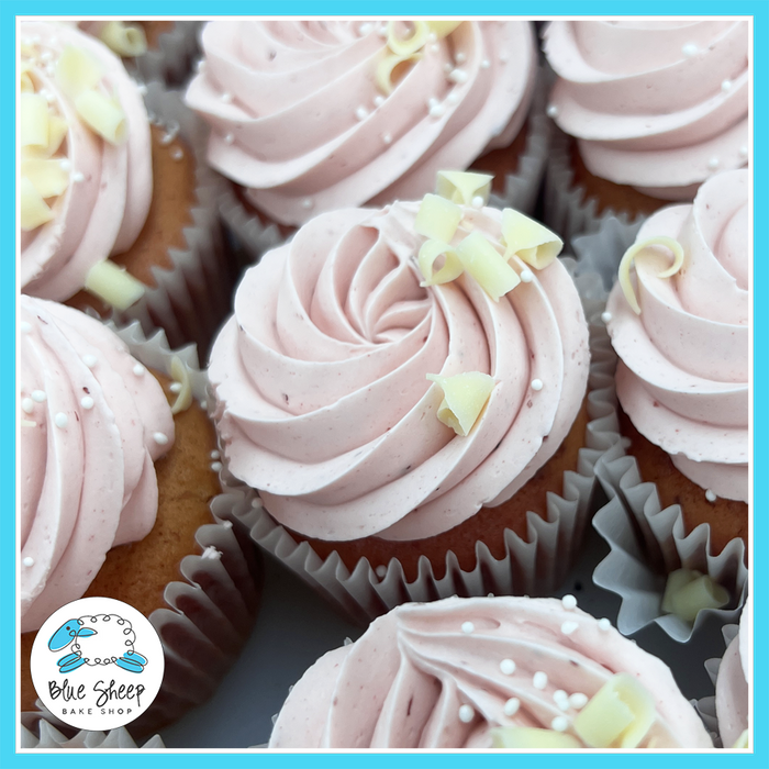 Strawberry Fields cupcakes with pink strawberry buttercream, white chocolate curls, and sugar pearls – Blue Sheep Bake Shop