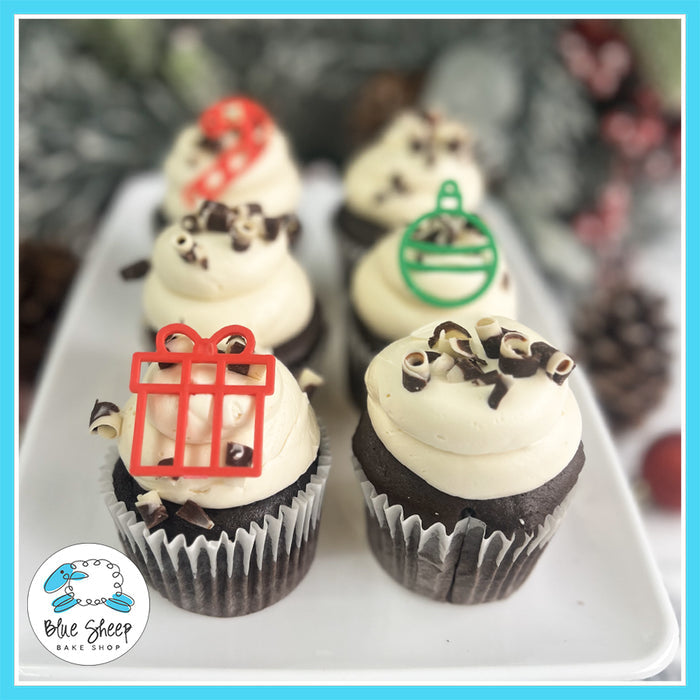 Baileys Hot Cocoa Cupcakes with chocolate cupcakes, Baileys-infused buttercream, chocolate curls, and festive Christmas toppers.