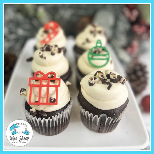 Baileys Hot Cocoa Cupcakes with chocolate cupcakes, Baileys-infused buttercream, chocolate curls, and festive Christmas toppers.