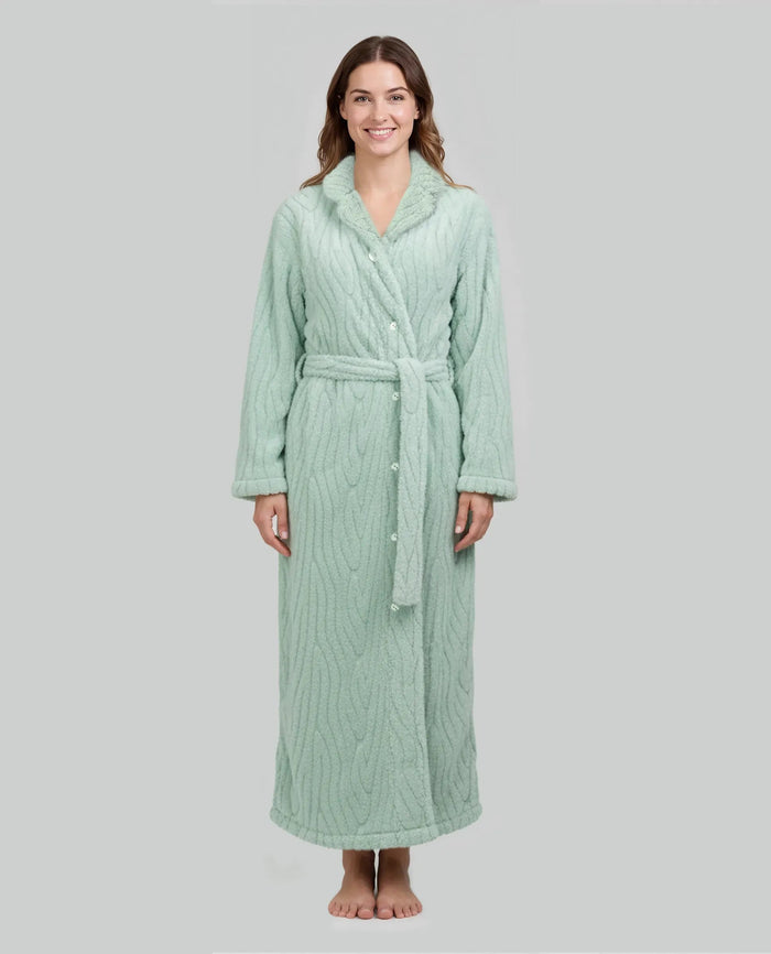 Mujer luce bata larga verde claro con textura, abotonada mas cinturón y bolsillos