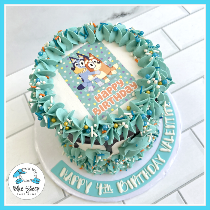 Bluey and Bingo birthday cake with teal buttercream swirls and sprinkles | Blue Sheep Bake Shop in Somerville NJ