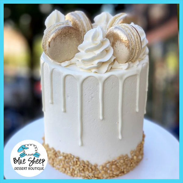 gold glam macron drip cake