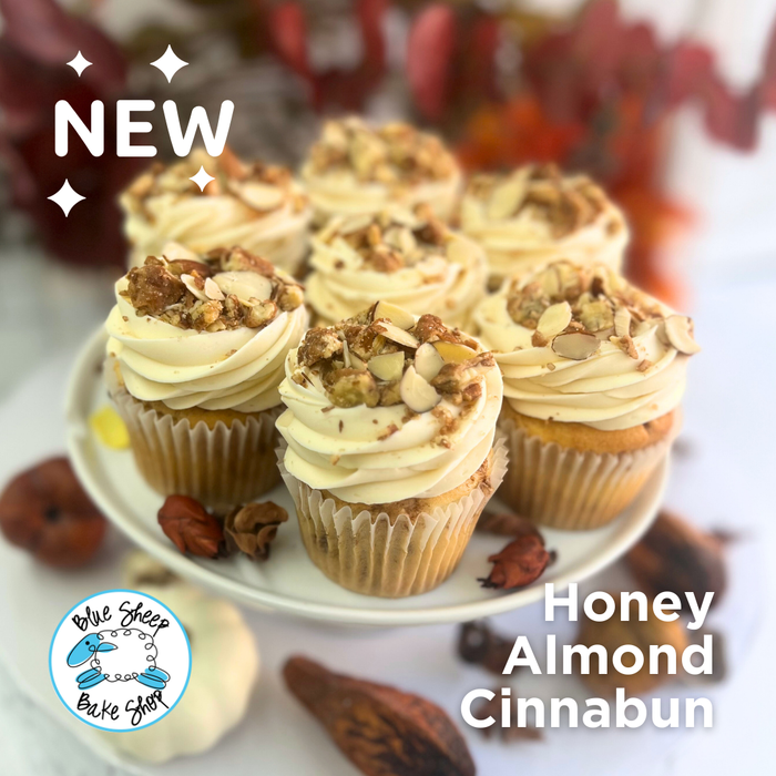 Honey Almond Cinnabun Cupcakes topped with honey buttercream, toasted almonds, and drizzled honey
