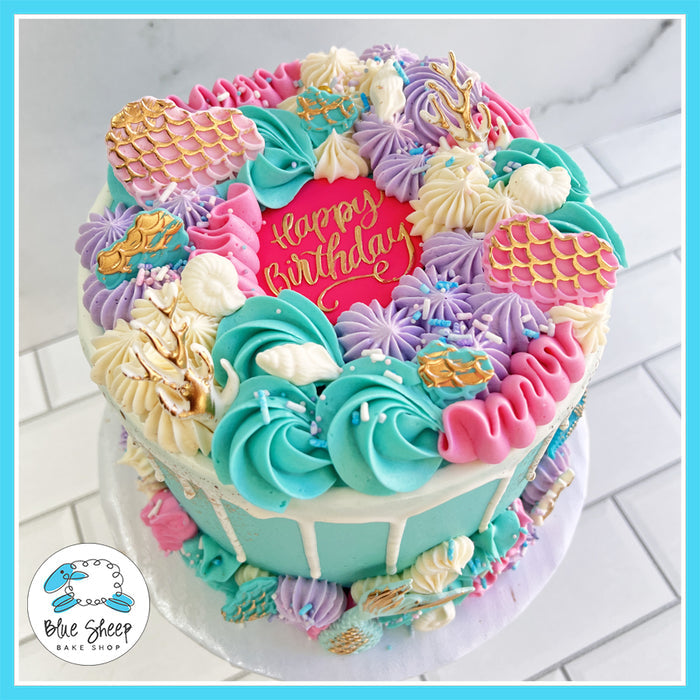 Mermaid Magic birthday cake with pastel buttercream, edible seashells, and mermaid tails by Blue Sheep Bake Shop in Somerville, NJ.
