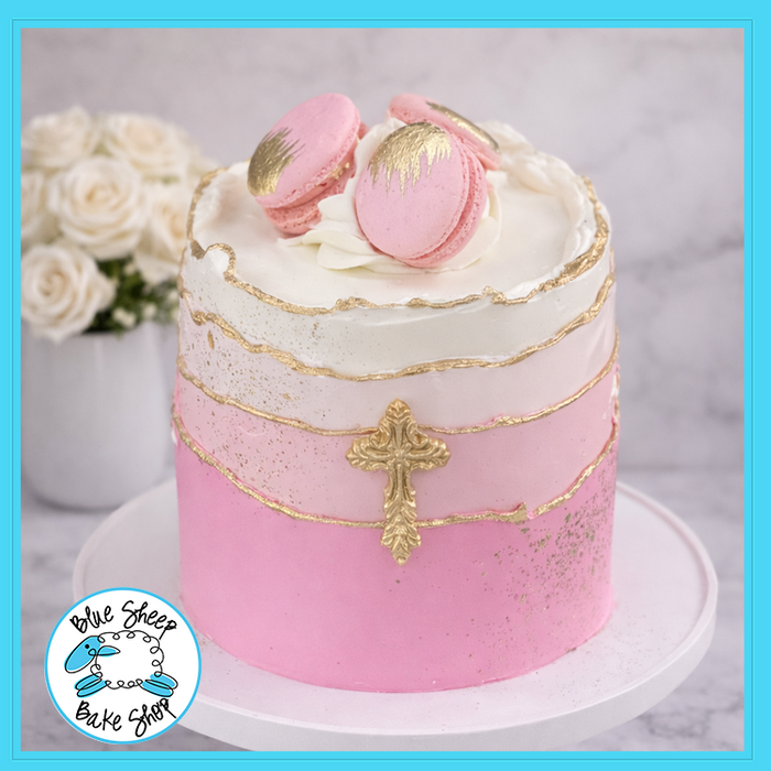 Pink first communion cake with gold cross and macarons from Blue Sheep Bake Shop in Somerville NJ