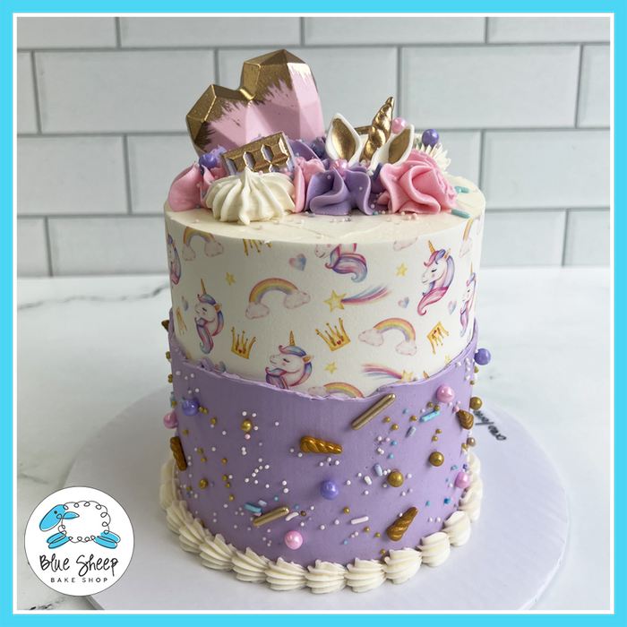 Pastel unicorn birthday cake with edible print, buttercream swirls, sprinkles, and a breakable heart from Blue Sheep Bake Shop in Somerville NJ